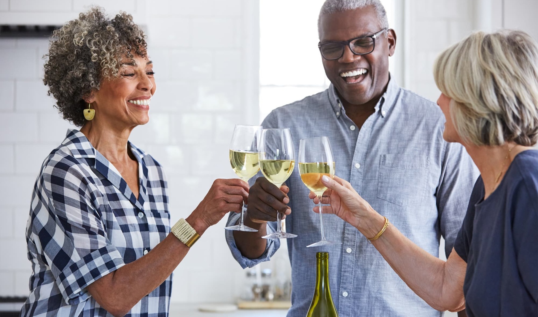 three people with drinks indoors